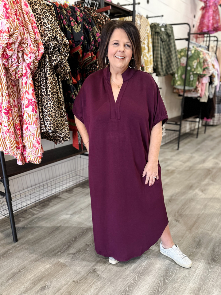 Woman wearing a purple dress in a clothing store
